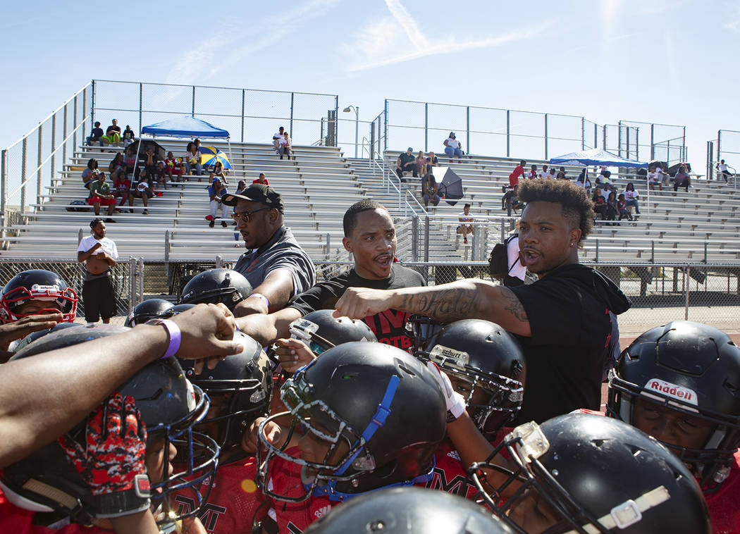 Devin Conway, center, huddles before the TMT Red Lions game at Bonanza High School on Saturday, ...