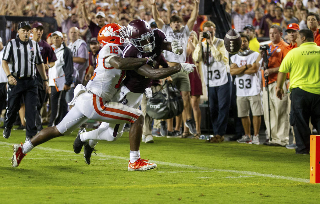 Texas A&M wide receiver Quartney Davis (1) has the ball punched out of his hands for a touc ...