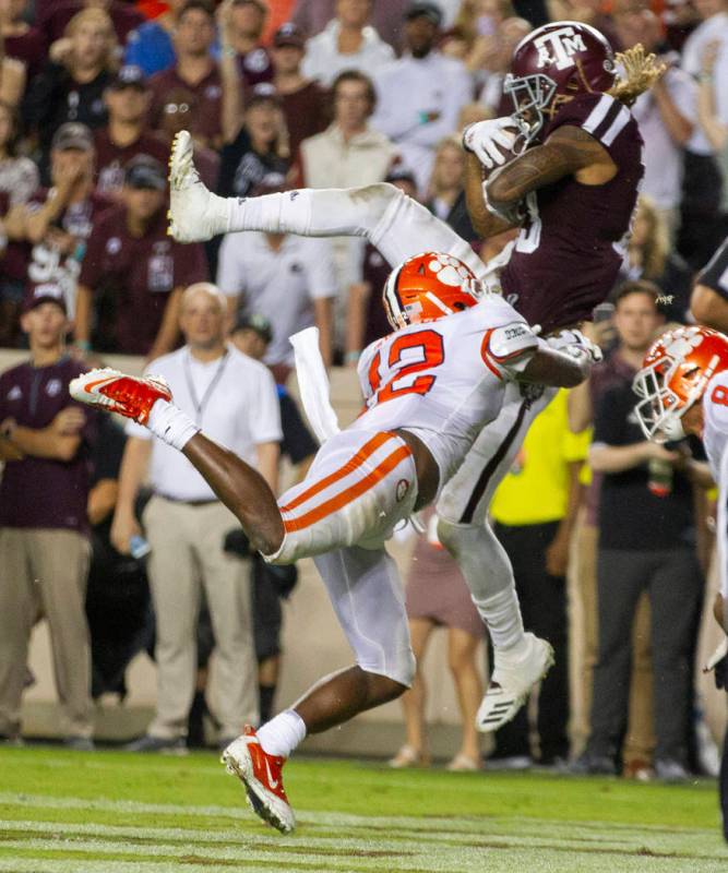 Texas A&M wide receiver Kendrick Rogers, top,catch a pass for a touchdown as Clemson defens ...