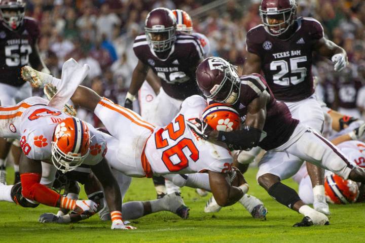 Texas A&M defensive back Donovan Wilson (6) stops Clemson running back Adam Choice (26) sho ...