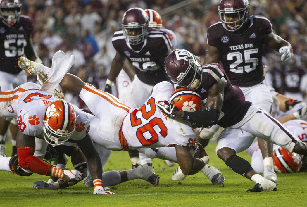 Texas A&M defensive back Donovan Wilson (6) stops Clemson running back Adam Choice (26) sho ...