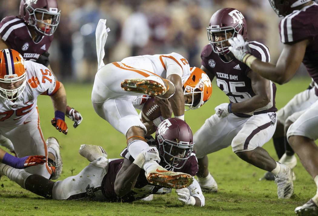 Texas A&M linebacker Otaro Alaka (42) upends Clemson quarterback Kelly Bryant (2) after a s ...