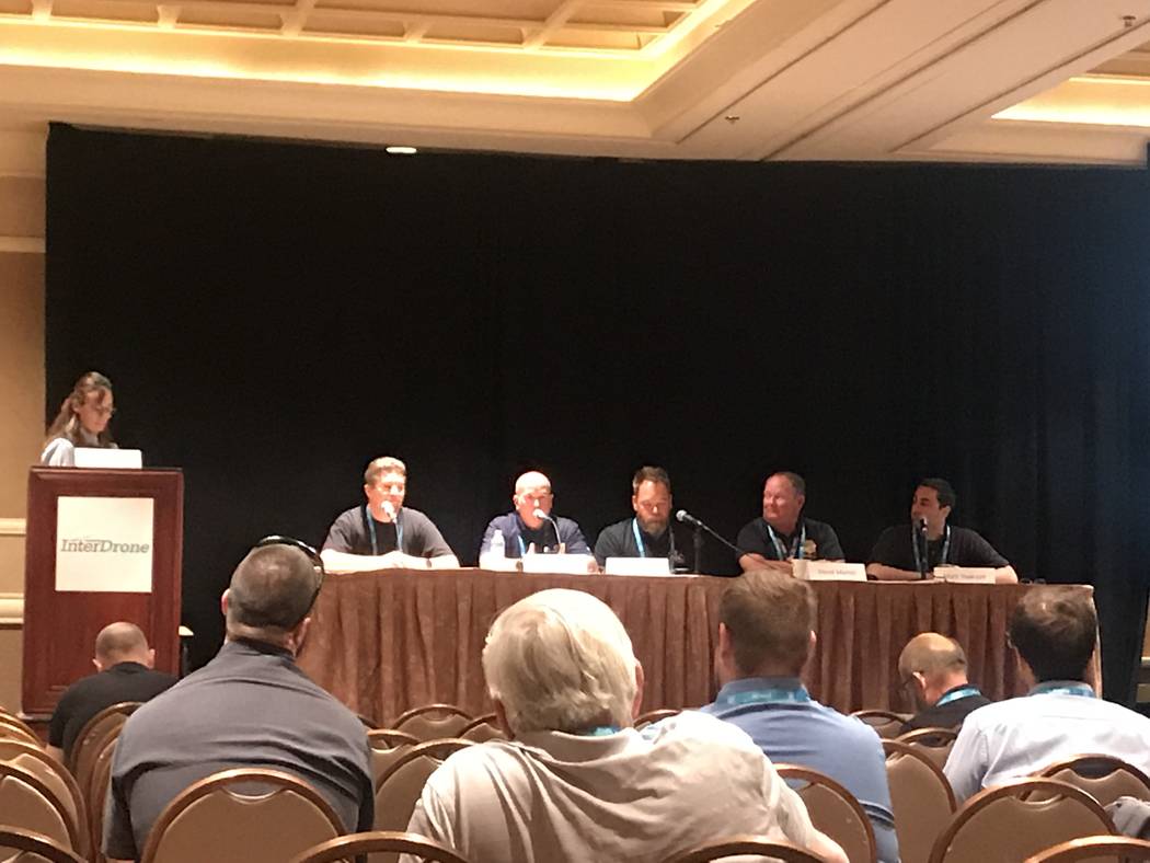 Tim Martin of Huntington Beach Police Department, third from left, discusses how the department ...