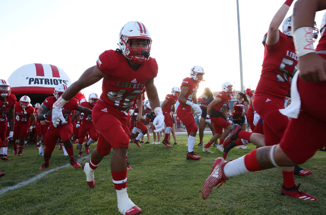 The Liberty High school football players take the field against Chandler, Ariz., in 2018 in Hen ...