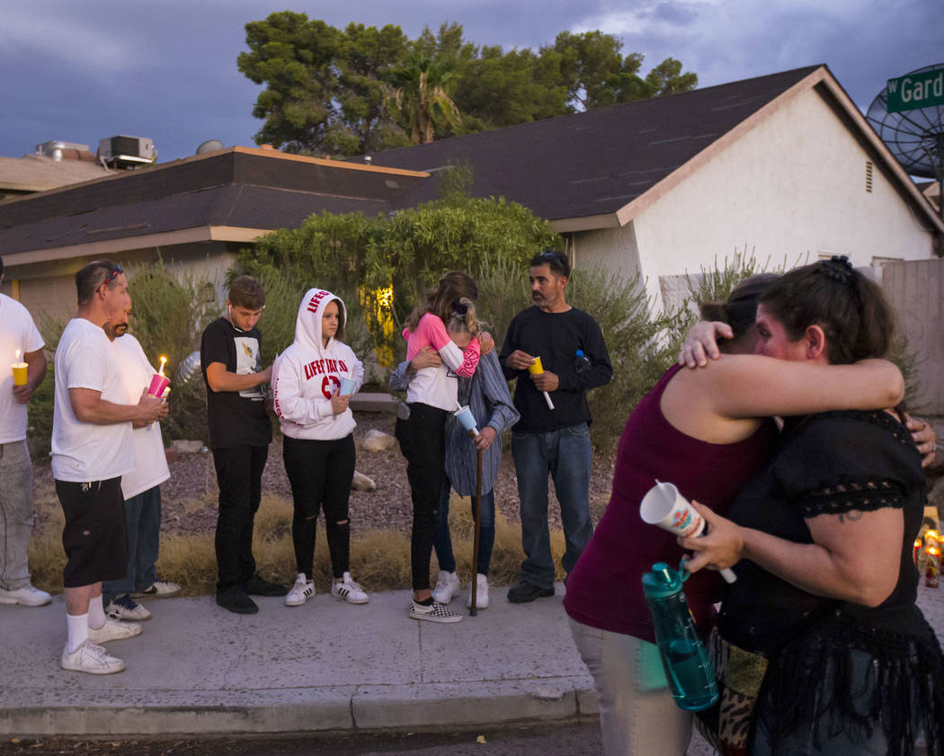 Kelsi Jackson, 15, center, hugs her grandmother, Mary Ann Ratay, during a vigil in memory of Je ...