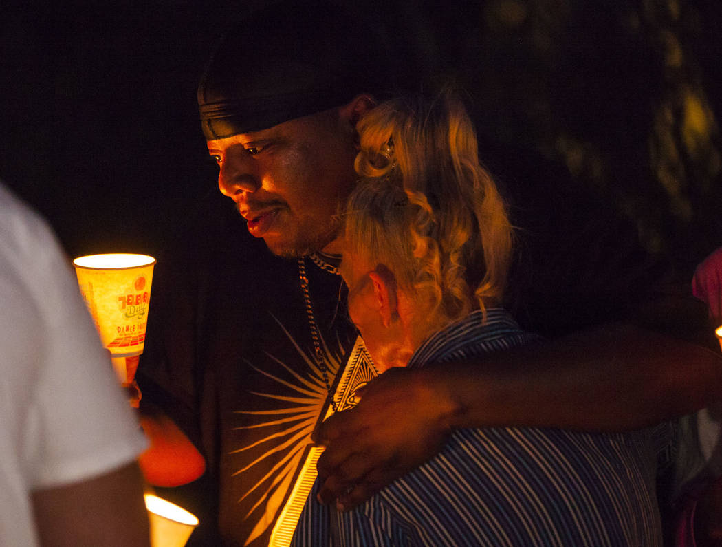 Mario Smith comforts Mary Ann Ratay during a vigil in memory of Jennifer Ratay, daughter of Mar ...