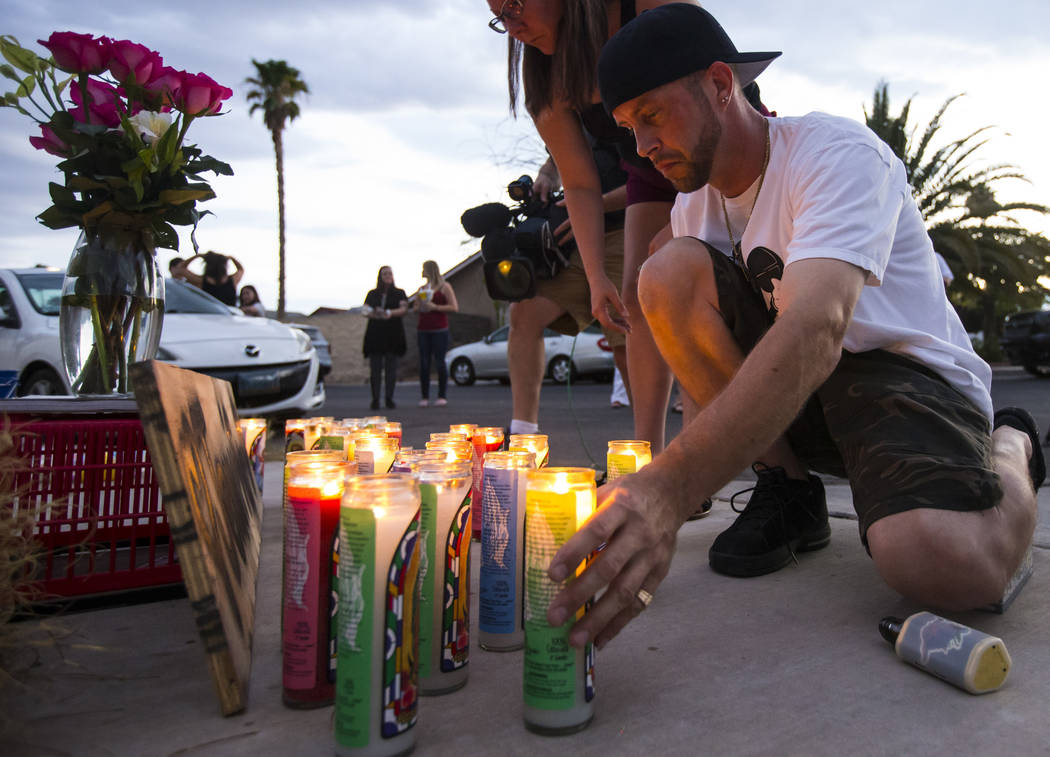 Ted Hamilton lights candles before the start of a vigil in memory of Jennifer Ratay outside of ...