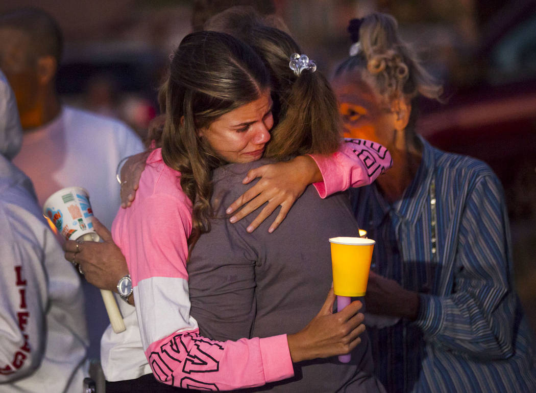Kelsi Jackson, 15, center left, is comforted during a vigil in memory of her mother, Jennifer R ...