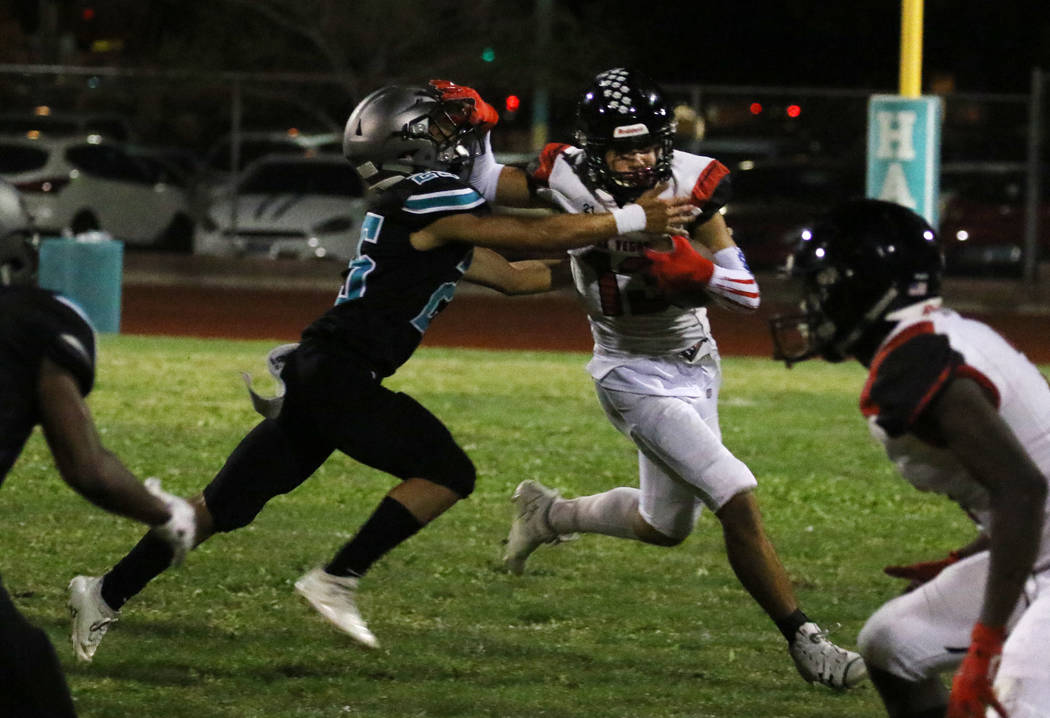 Las Vegas High's wide receiver Dalten Silet (13) avoids a tackle from Silverado High's Jeremy A ...