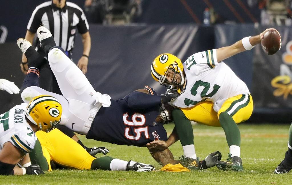 Chicago Bears' Roy Robertson-Harris sacks Green Bay Packers' Aaron Rodgers during the first hal ...
