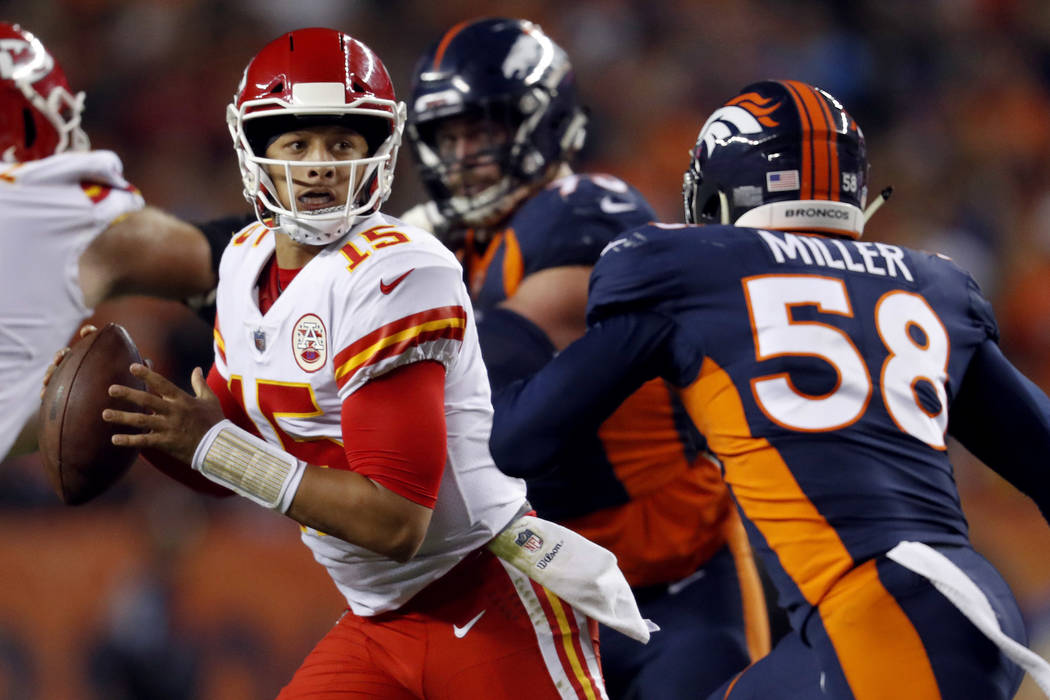 Kansas City Chiefs quarterback Patrick Mahomes (15) scrambles as Denver Broncos linebacker Von ...