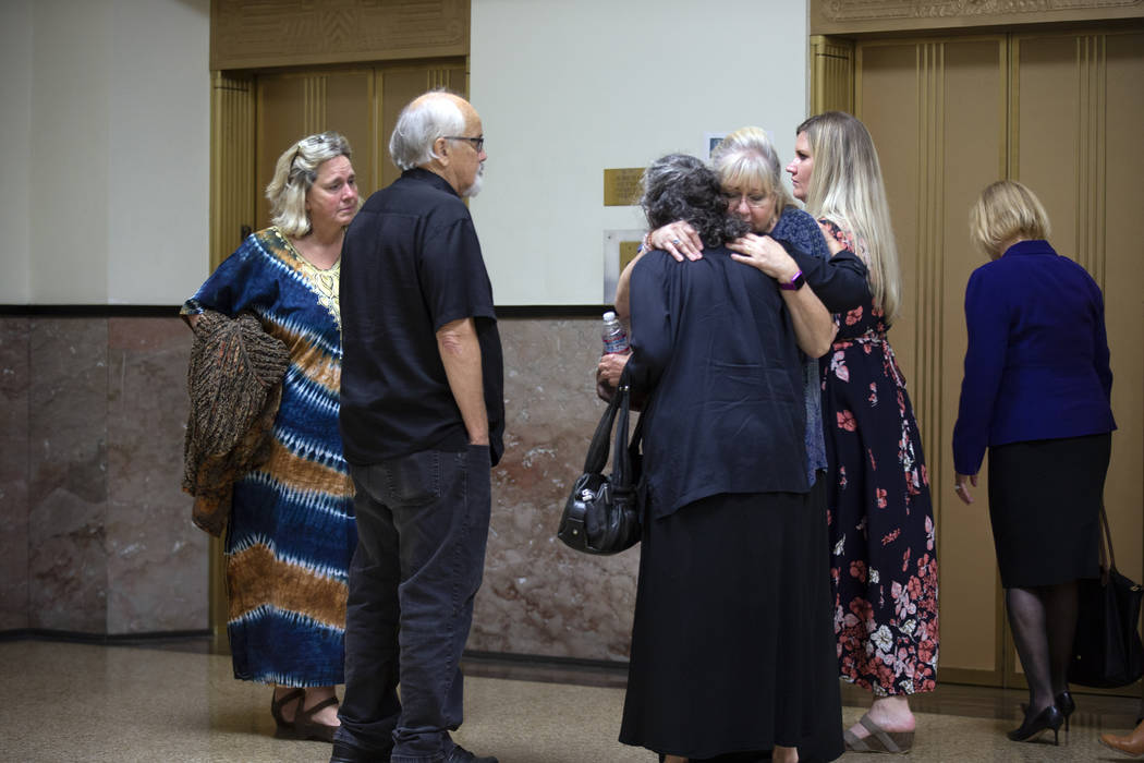 Family members of the victims hug each other after learning of the not guilty verdicts in the G ...