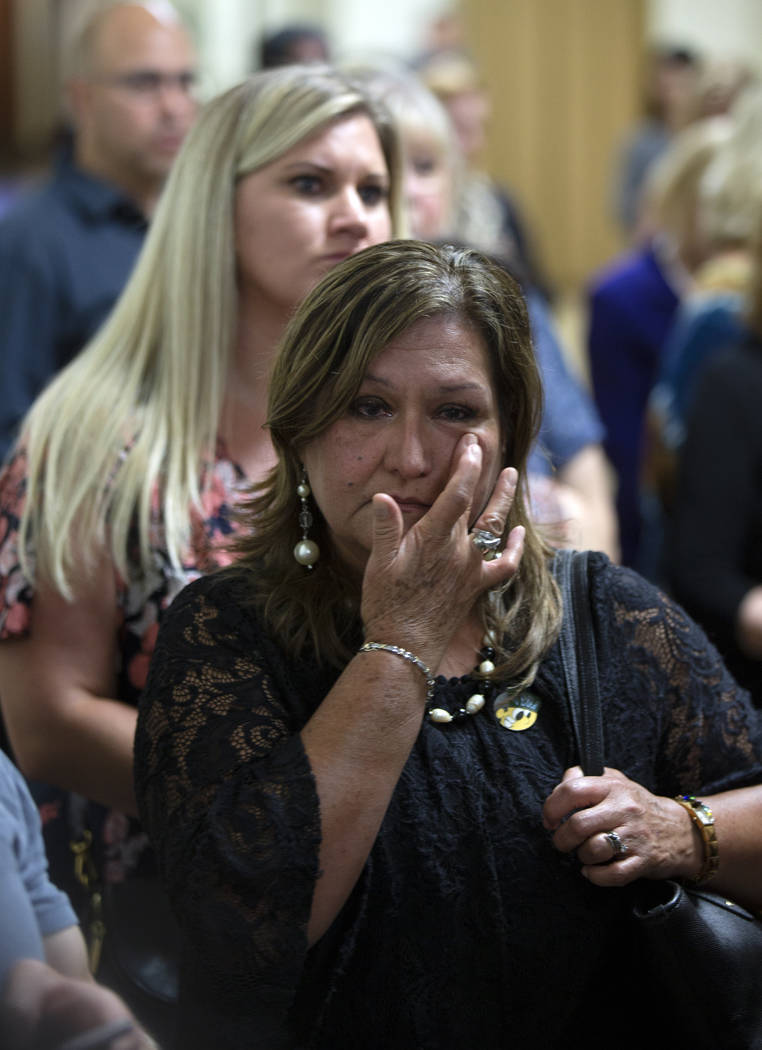 Esperanza Gonzalez, aunt of fire victim Alex Vega, wipes away tears as she listens to comments ...