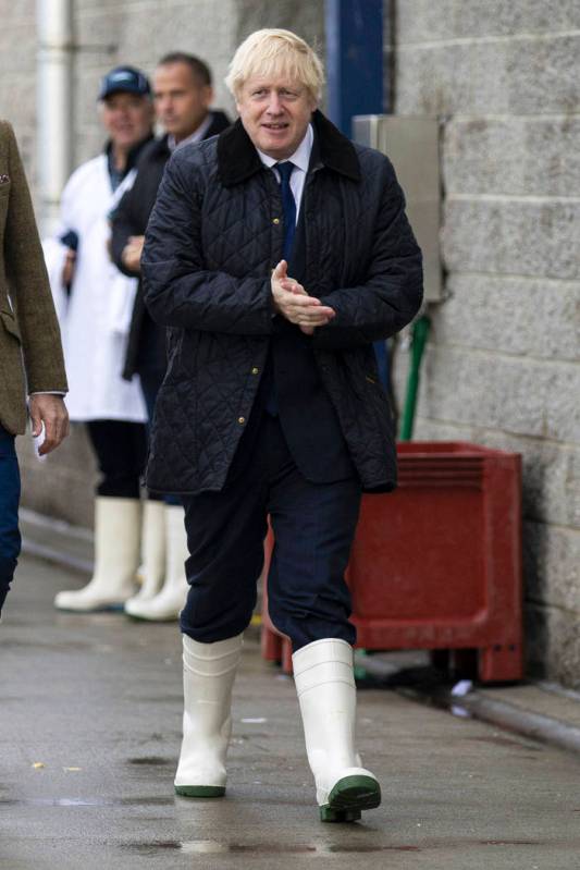 Britain's Prime Minister Boris Johnson leaves after a visit to Peterhead fish market near Aberd ...