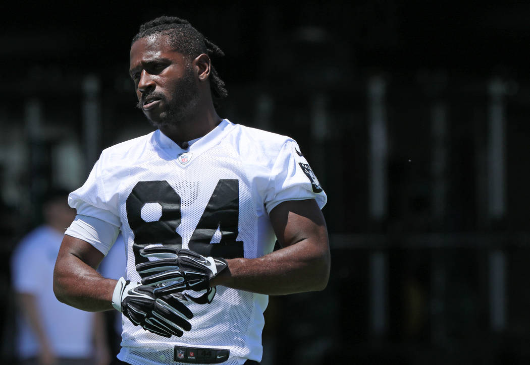 Oakland Raiders wide receiver Antonio Brown (84) stretches on the sideline during mandatory min ...