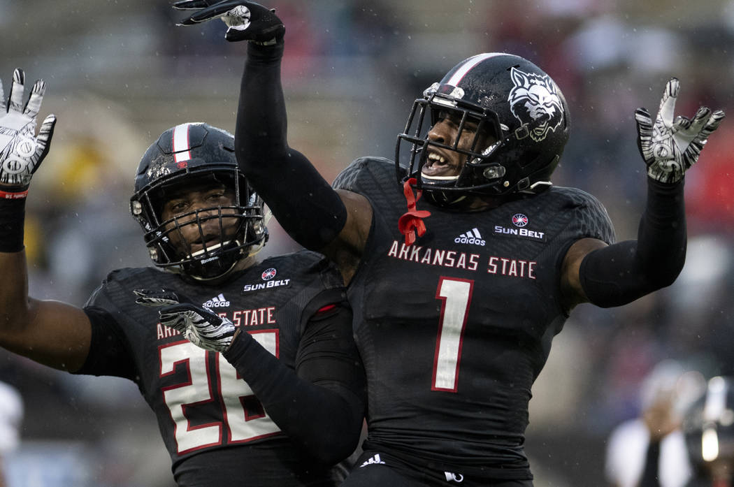 Arkansas State cornerback Jerry Jacobs (1) and linebacker Trent Ellis-Brewer (26) celebrate a p ...