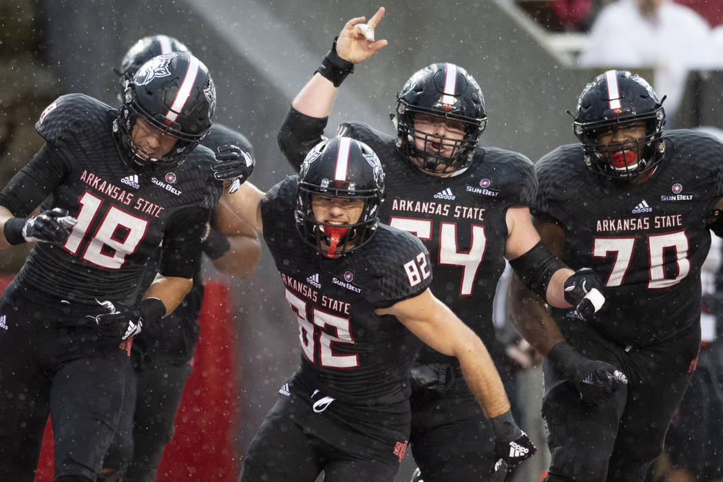 Arkansas State players celebrate a touchdown in the first quarter against UNLV during an NCAA c ...