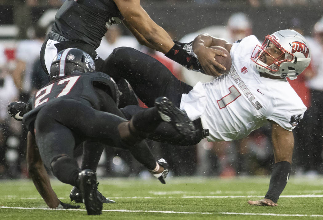 UNLV quarterback Armani Rogers (1) is brought to the ground by Arkansas State linebacker Caleb ...