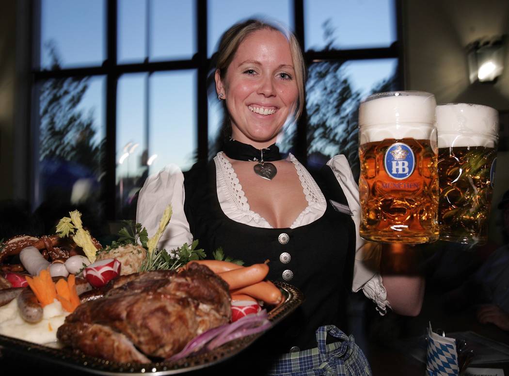 Anastasia Danesi holds up beer and food at the Hofbrauhaus on Wednesday, Sept. 23, 2004. (Phot ...