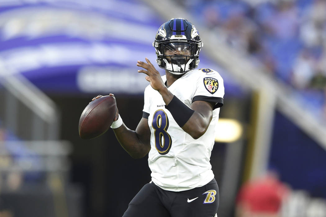 Baltimore Ravens quarterback Lamar Jackson looks to pass against the Green Bay Packers during t ...