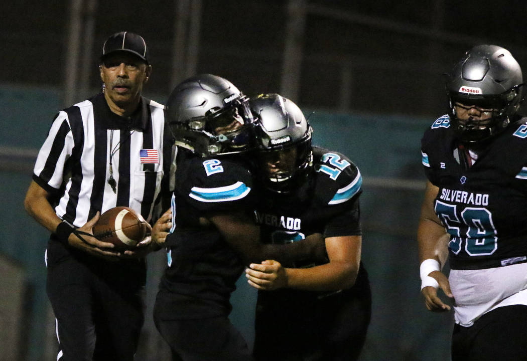 Silverado High's running back Aginae Cunningham (2) celebrates his touchdown with his teammate ...