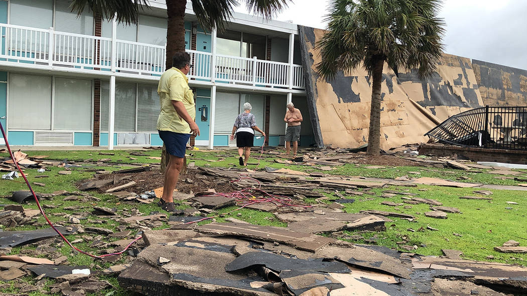 Residents of the Bogue Shores condominiums work to hook up a generator after the complex lost i ...