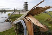 Utility poles were shipped after Hurricane Dorian moved through the area yesterday along a caus ...