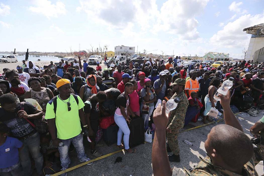 A Bahama's Army officer delivers water to the people evacuated prior boarding a ferry to Nassau ...