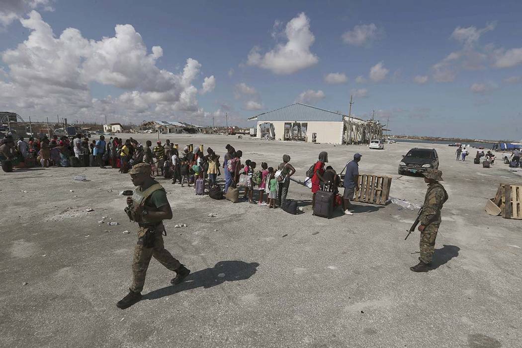 People line up prior boarding a ferry to Nassau at the Port in Marsh Harbor, Abaco Island, Baha ...