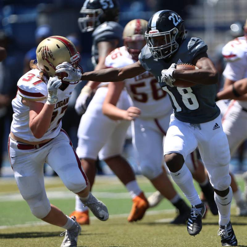 Desert Pines' Ja' Juan Pollard (18) runs the for a touchdown against Logan's Andrew Thompson (3 ...