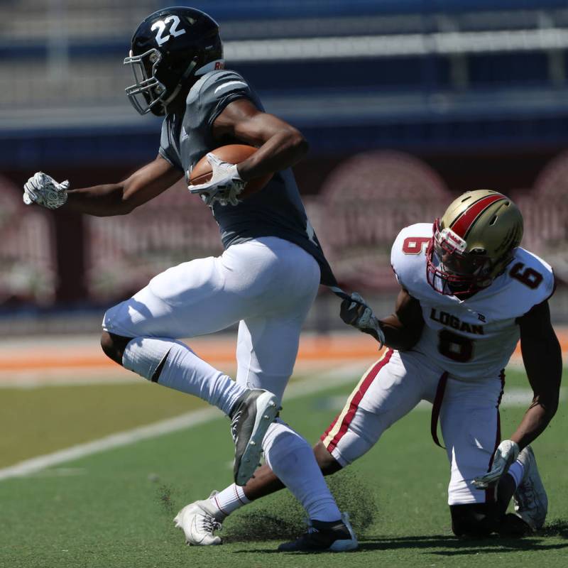 Desert Pines' Javontae Barnes (22) runs the ball for a touchdown against Logan's Isaac Larsen ( ...