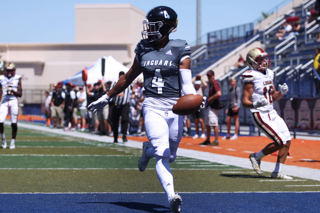 Desert Pines' Branden Thomas (4) scores a touchdown against Logan during the first quarter of t ...