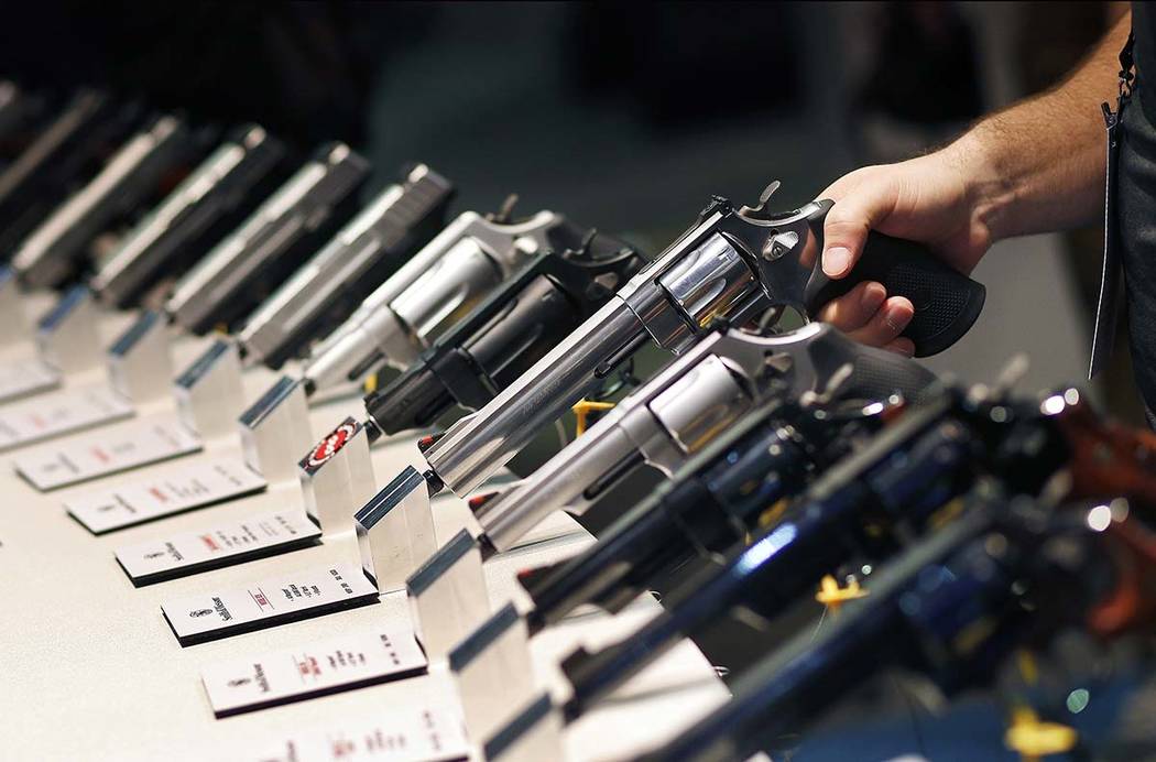 In this Jan. 19, 2016 file photo, handguns are displayed at the Smith & Wesson booth at the Sho ...