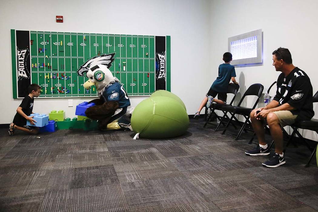 In this Thursday, Aug. 22, 2019, photo, Victor Ykoruk, right, watches as his 10-year-old twin s ...