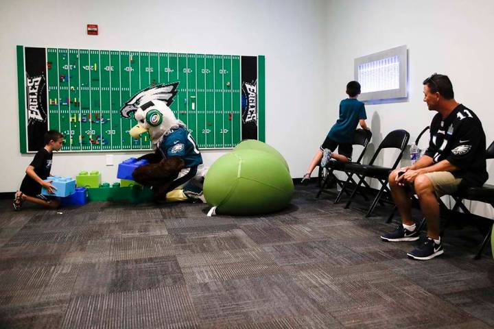 In this Thursday, Aug. 22, 2019, photo, Victor Ykoruk, right, watches as his 10-year-old twin s ...