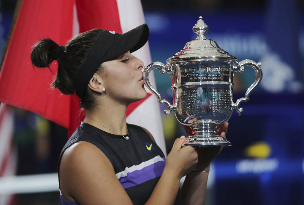 Bianca Andreescu, of Canada, kisses the championship trophy after defeating Serena Williams, of ...