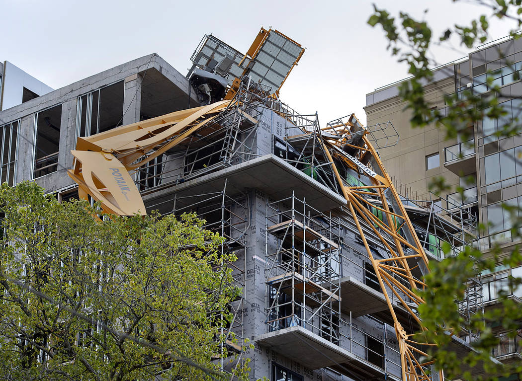 A toppled building crane is draped over a new construction project after Hurricane Dorian swept ...