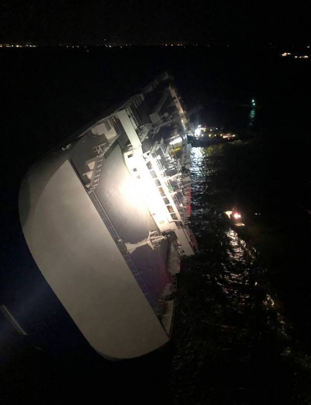 In this photo provided by the U.S. Coast Guard, the Golden Ray cargo ship lists to one side nea ...