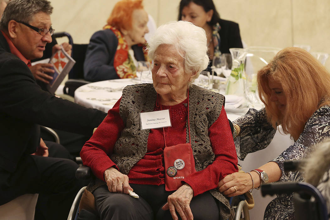 Janine Mazur, center, listens to speeches during an event to honor Polish people who saved Jews ...