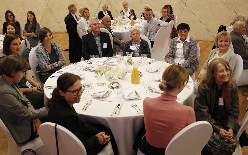 Polish people who saved Jews during WWII sit with family members and others during an event to ...