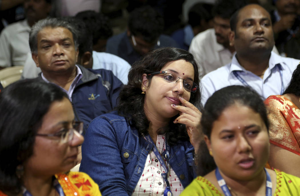 Indian Space Research Organization (ISRO) employees react after an announcement by organization ...