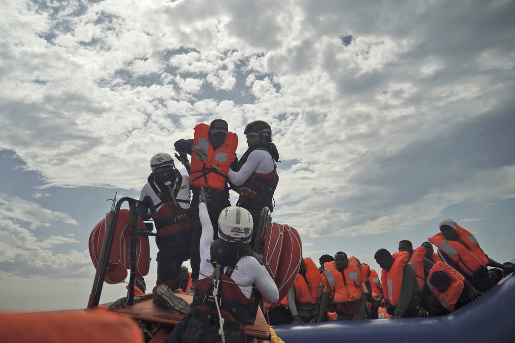 A person is transferred onto a rescue boat some 14 nautical miles from the coast of Libya in Me ...