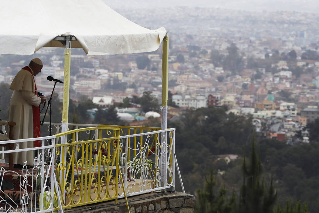 Pope Francis reads his message during a prayer for workers at the Mahatzana work yard, Madagasc ...