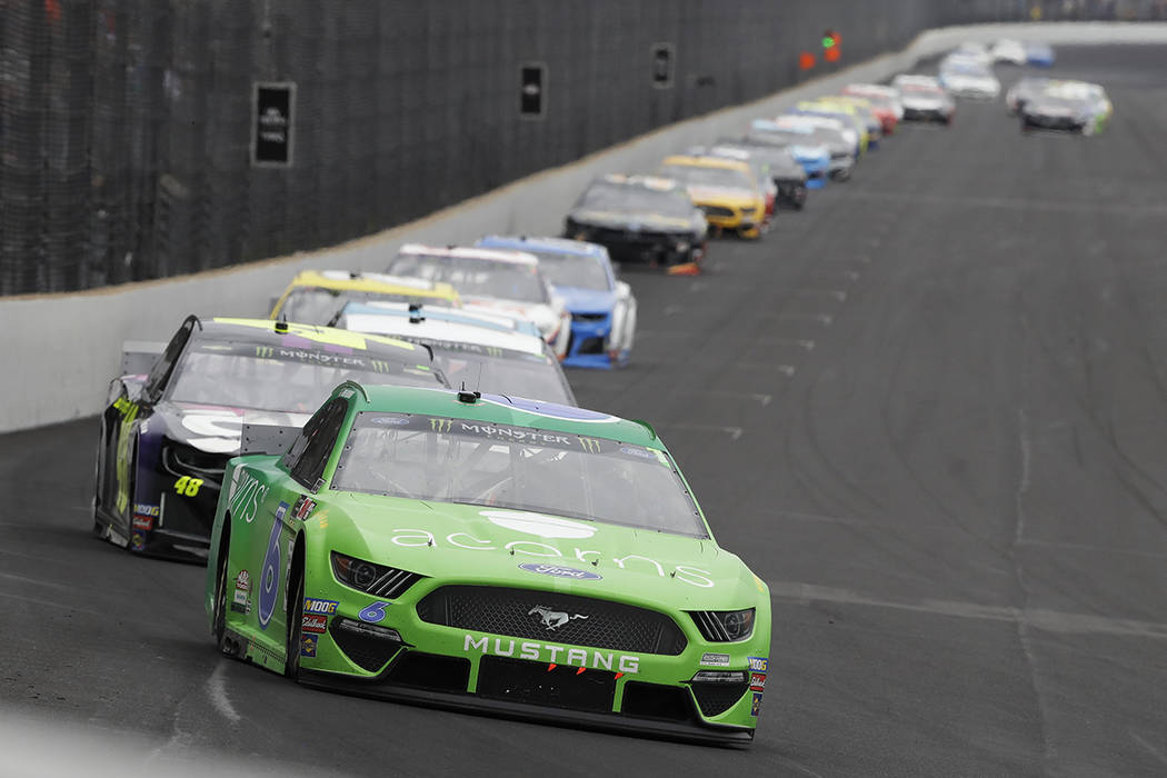 Ryan Newman leads driver Jimmie Johnson into Turn 1 during the NASCAR Brickyard 400 auto race a ...