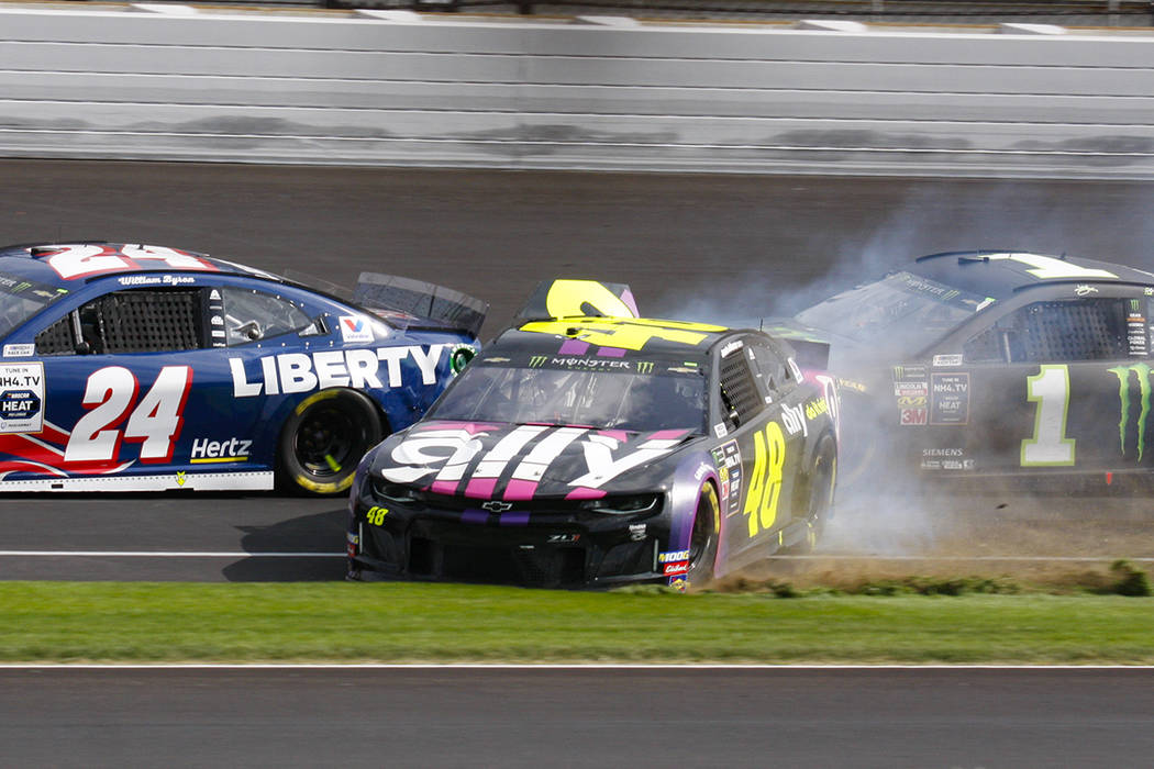 NASCAR driver Jimmie Johnson (48) makes contact with Kurt Busch (1) in the second turn during t ...