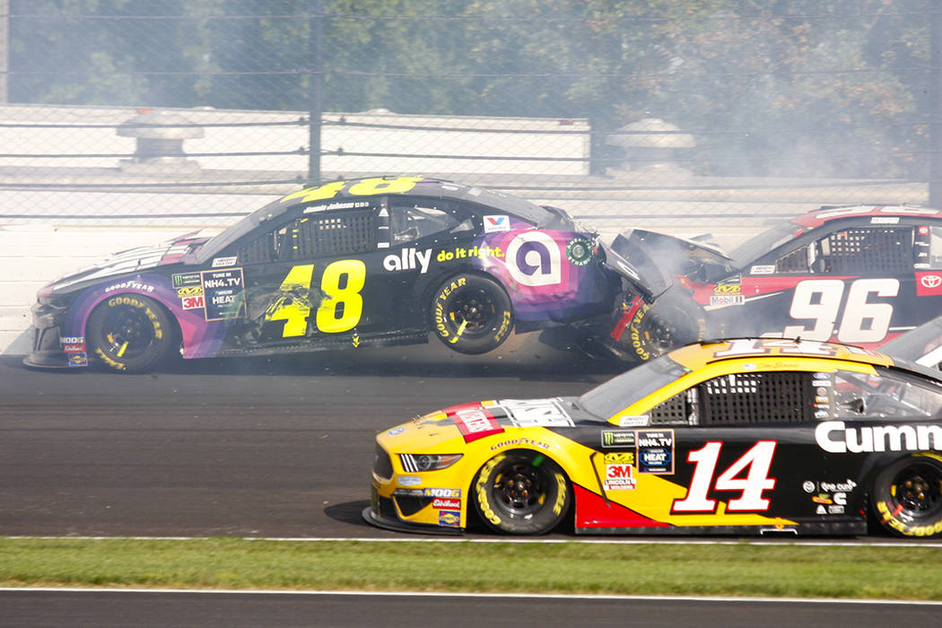 NASCAR driver Jimmie Johnson (48) is hit by Parker Kligerman (96) in the second turn during the ...