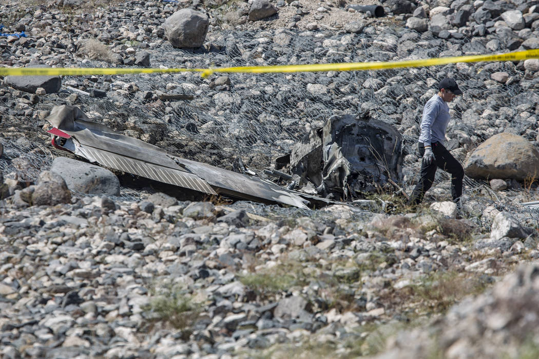 A Federal Aviation Administration employee investigates the scene of an airplane crash from Sat ...