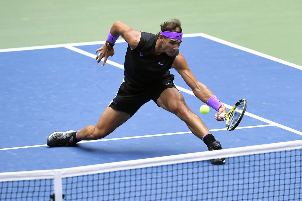 Rafael Nadal, of Spain, returns a shot to Daniil Medvedev, of Russia, during the men's singles ...