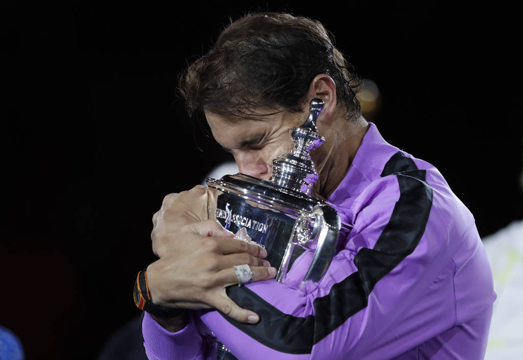 Rafael Nadal, of Spain, hugs the trophy after defeating Daniil Medvedev, of Russia, to win the ...