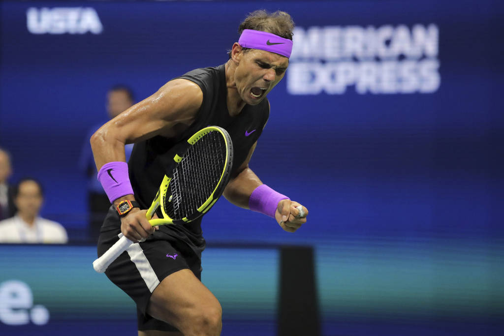 Rafael Nadal, of Spain, reacts after scoring a point against Daniil Medvedev, of Russia, during ...